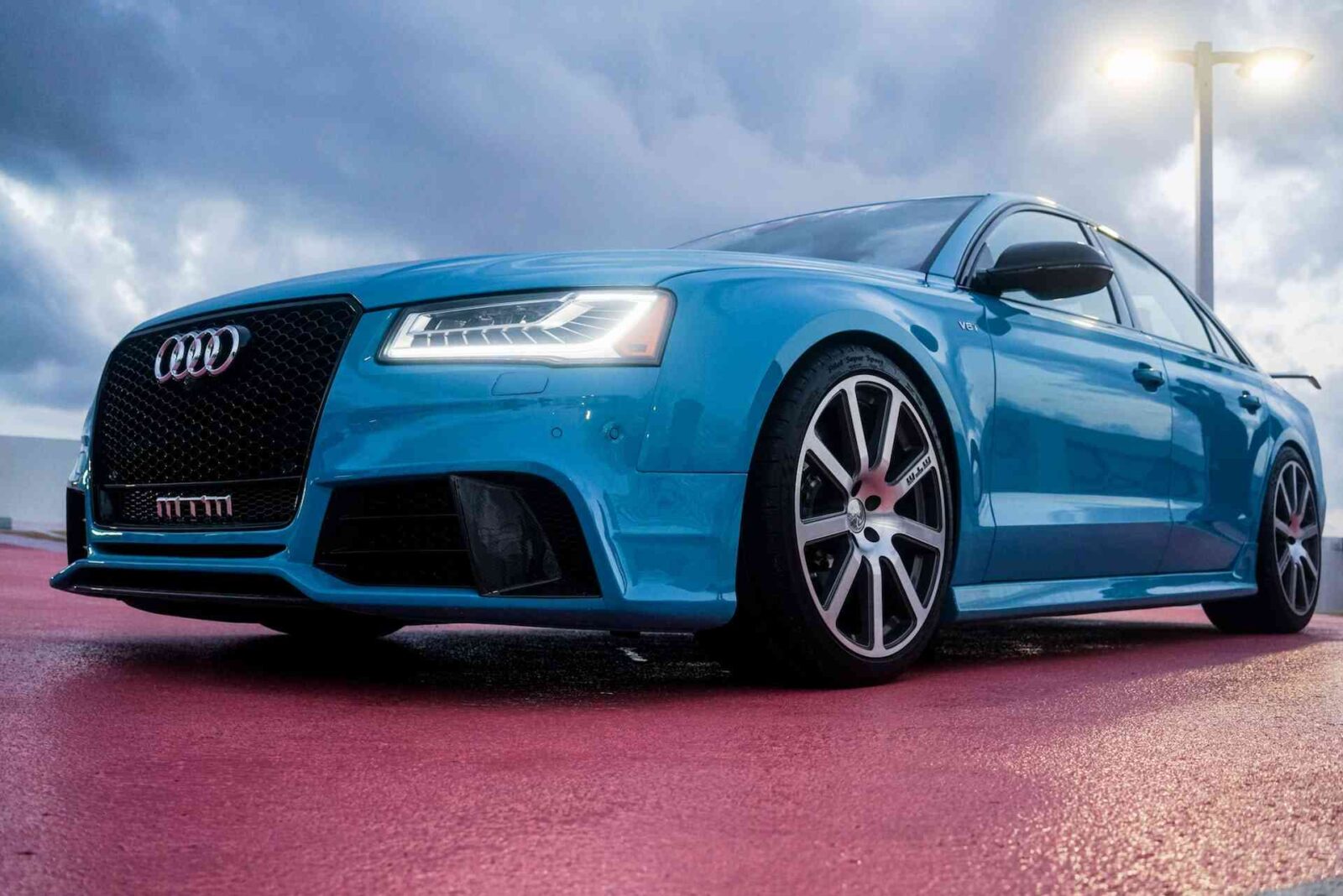 A close up shot of a blue BMW outside.