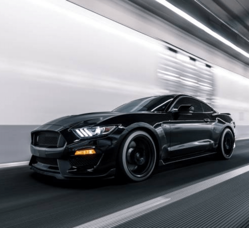 Black Car Driving at Speed