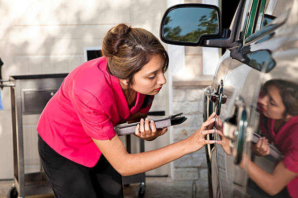 Insurance adjuster inspecting damage to vehicle.