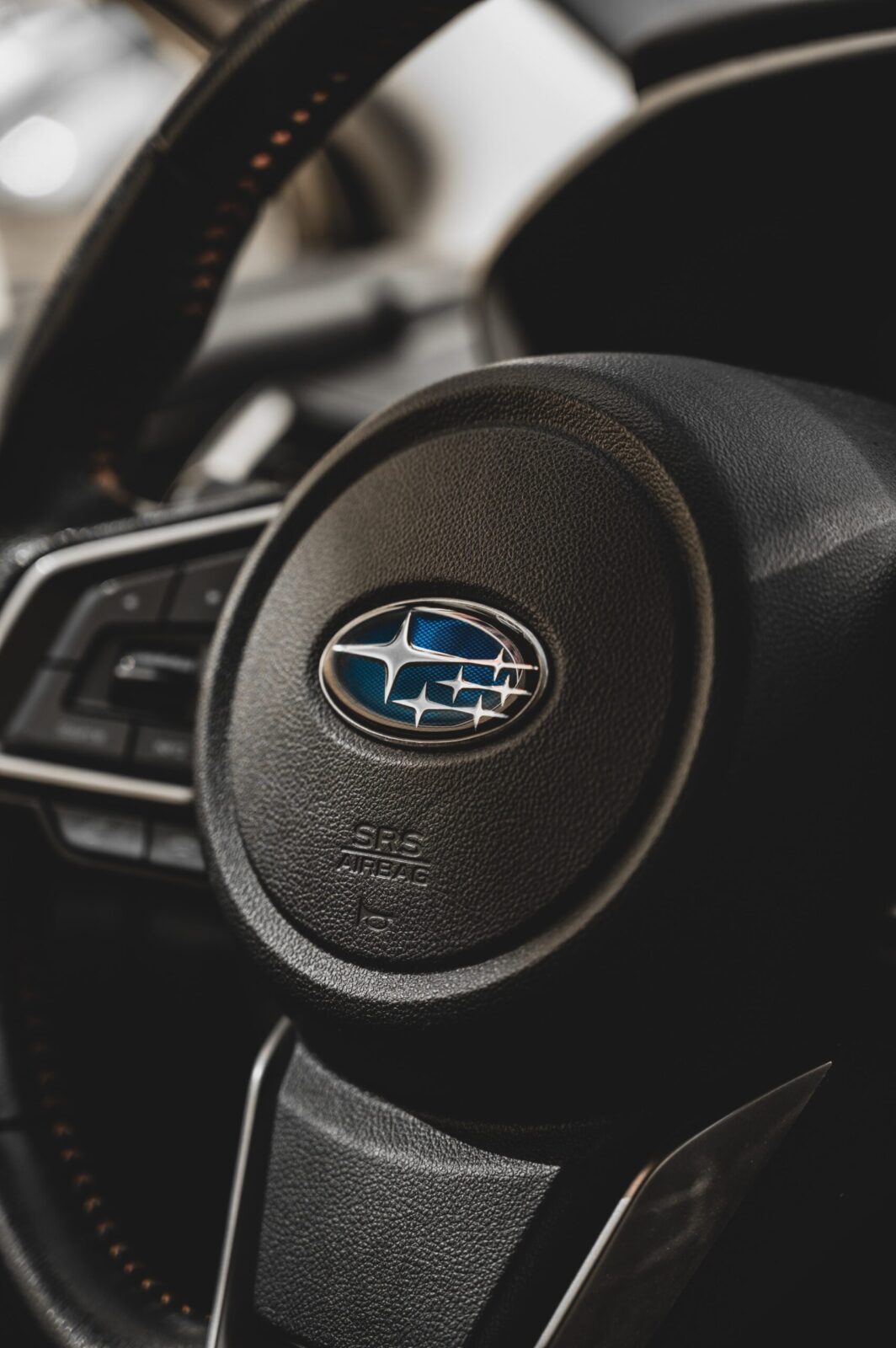 Subaru steering wheel closeup on logo